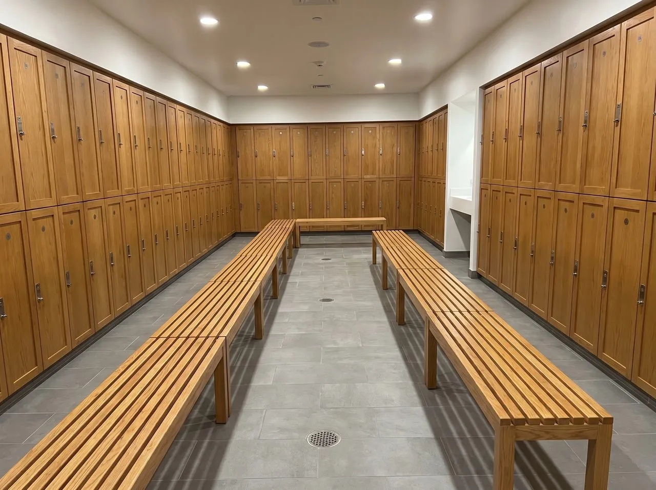 Clean gym locker room with floor drains