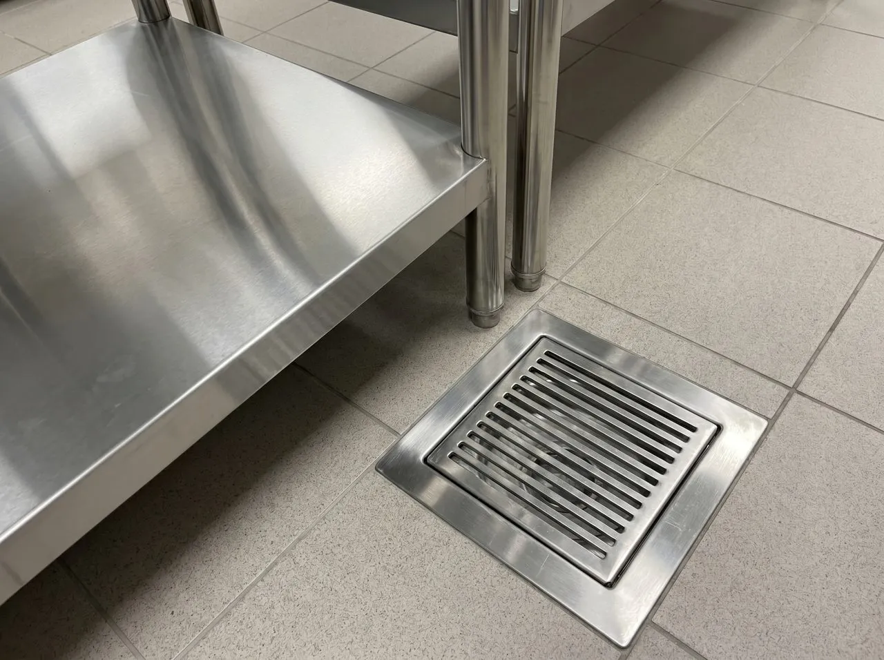 Stainless-steel floor drain in a commercial kitchen